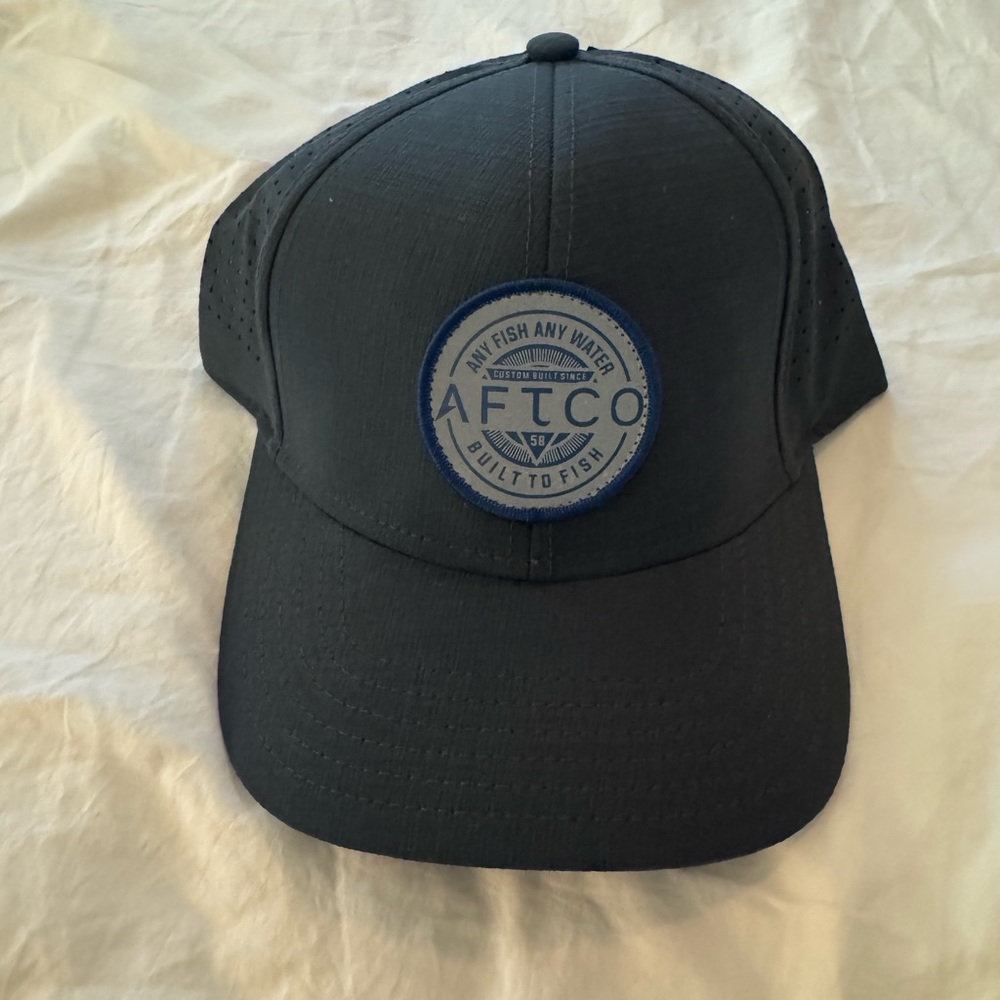 AFTCO Supernova Perforated Black Cap with Blue Tag